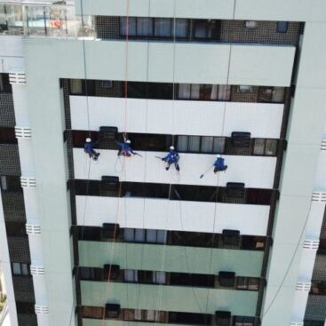 Colaboradores da SLEF Engenharia em acesso por cordas realizando a lavagem da fachada